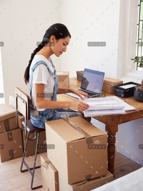 demo-attachment-139-woman-running-business-from-home-working-on-PCZKTN9